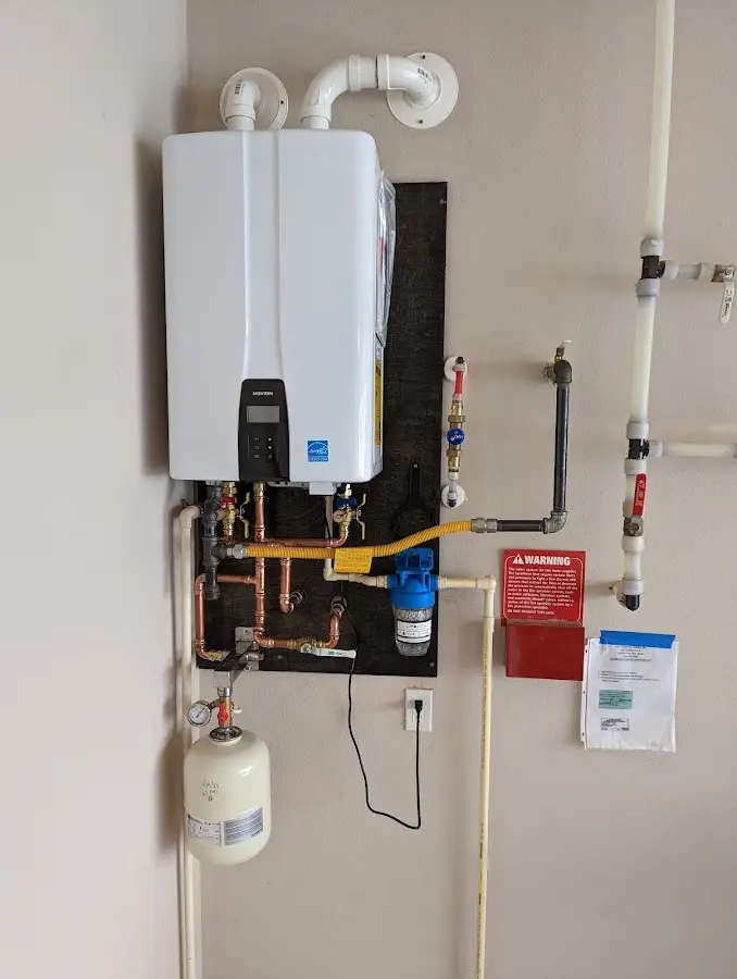 Professional plumber installing copper piping in a New York Mills home